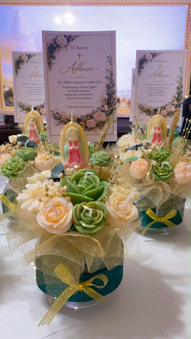 Baptism centerpieces with green and cream flower candles, a Virgin figure candle and Mi Bautizo cards