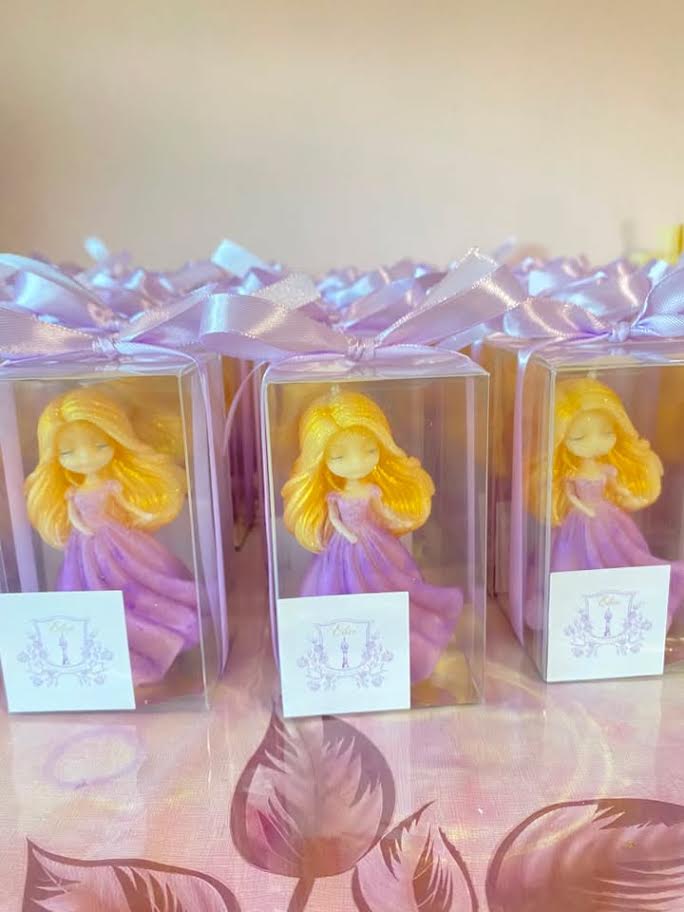 Rapunzel-inspired candle favors in clear boxes with lavender ribbon