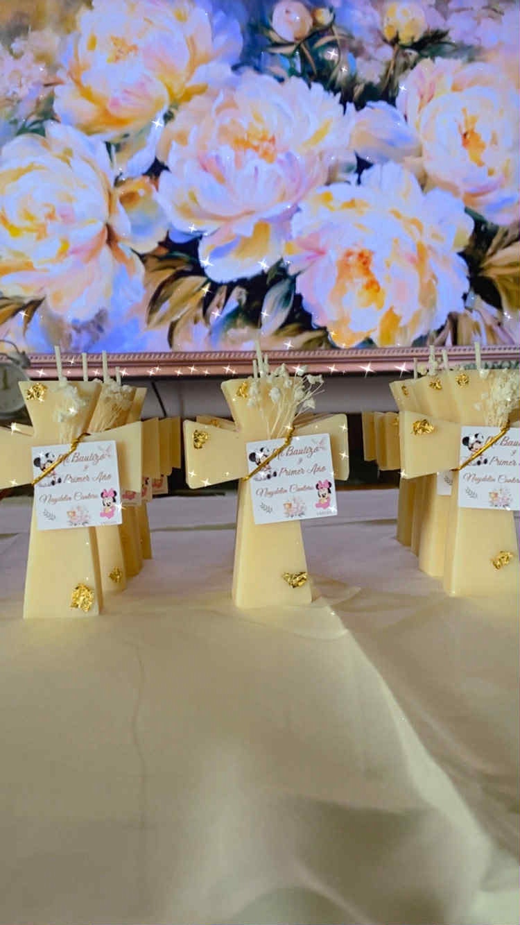 Classic Cross Candle keepsakes in cream wax with gold leaf detail and personalized baptism tags