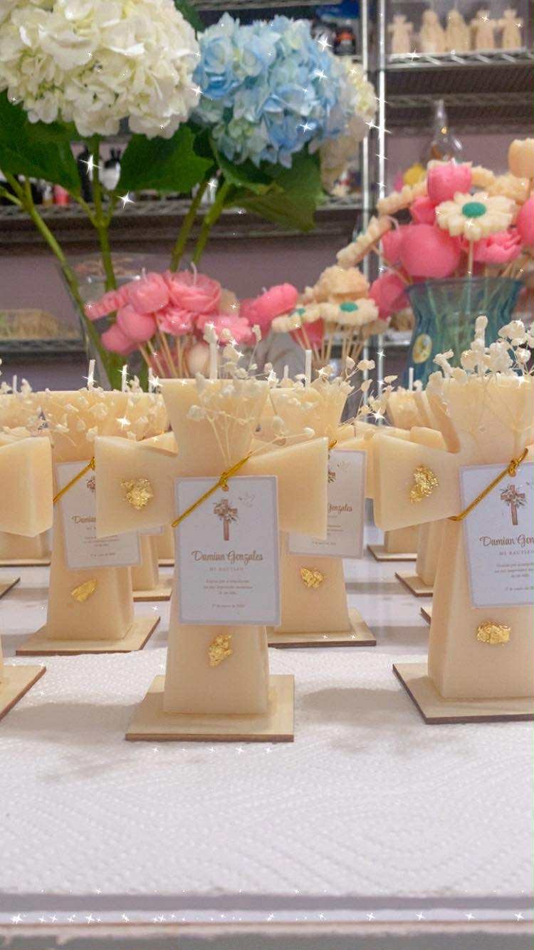 Classic Cross Candle keepsakes on wooden bases with gold detail and personalized event labels