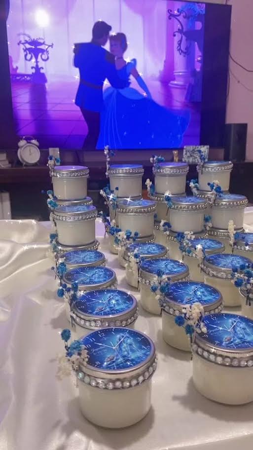 Themed 4 oz container candles with decorated lids on a table