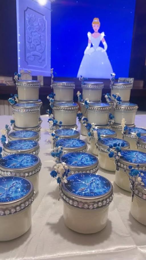 Themed 4 oz container candles with decorated lids on a table