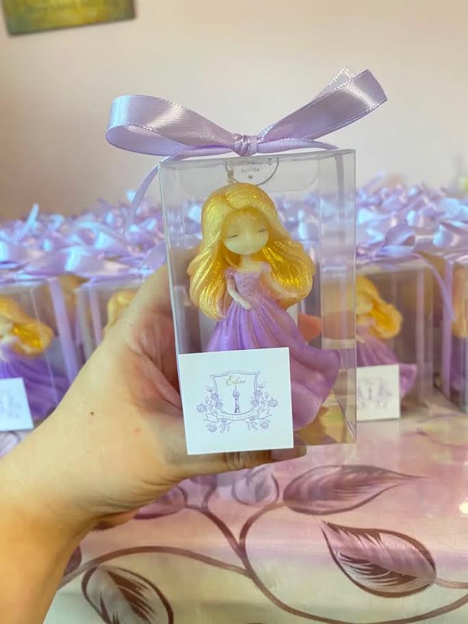 Rapunzel-inspired candle favors in clear boxes with lavender ribbon