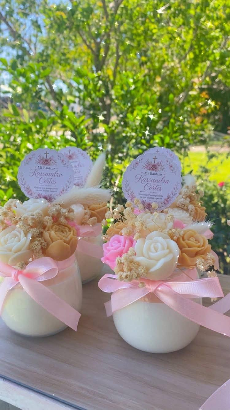 Three 8 oz bouquet candles with pink ribbons outdoors
