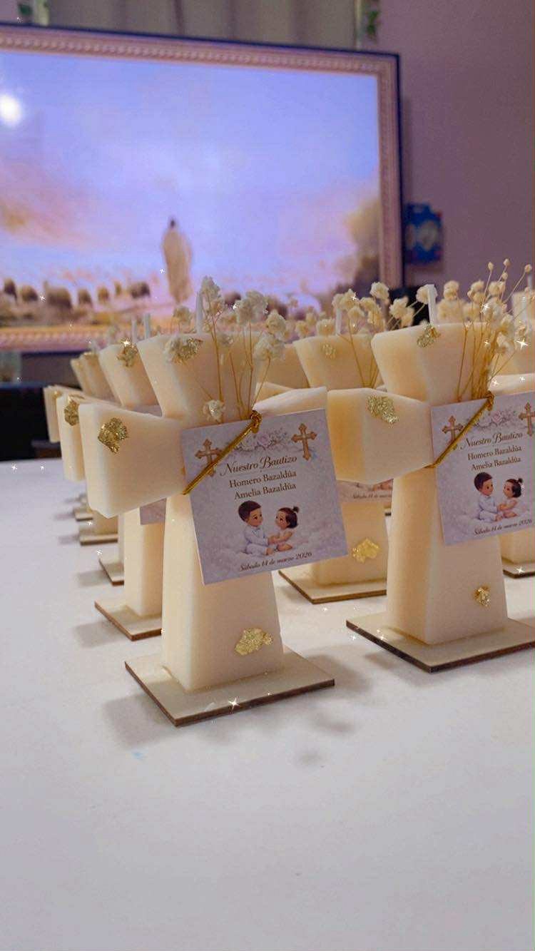 Rows of Classic Cross Candle keepsakes with white dried flowers and personalized baptism tags